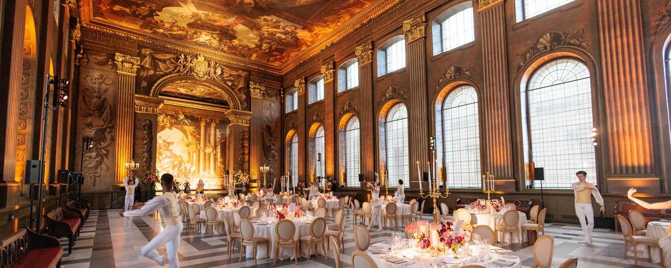 Dancers among the dinner tables in a painted baroque hall
